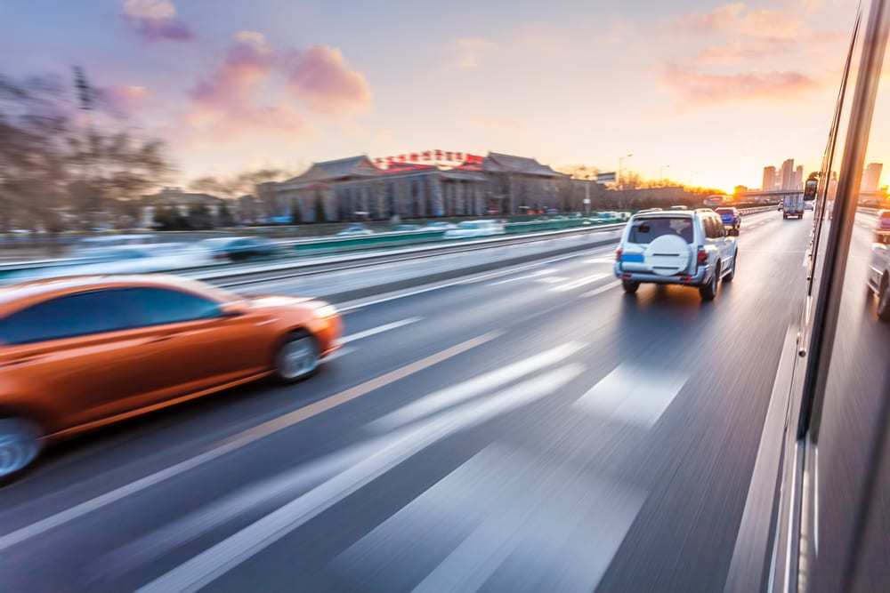 Car driving on freeway at sunset, motion blur