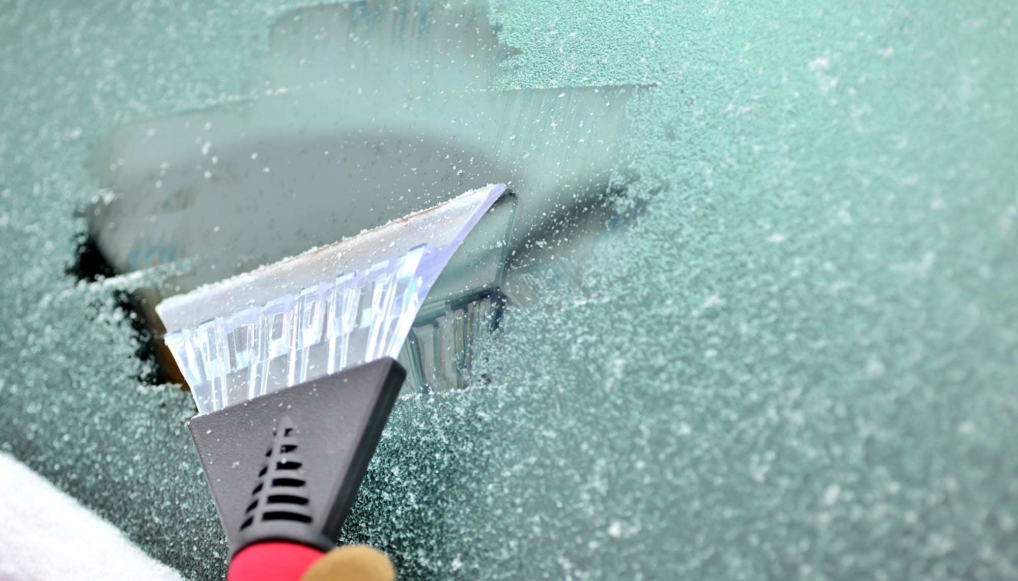 Ice-scraper-scraping-ice-off-a-car-windshield