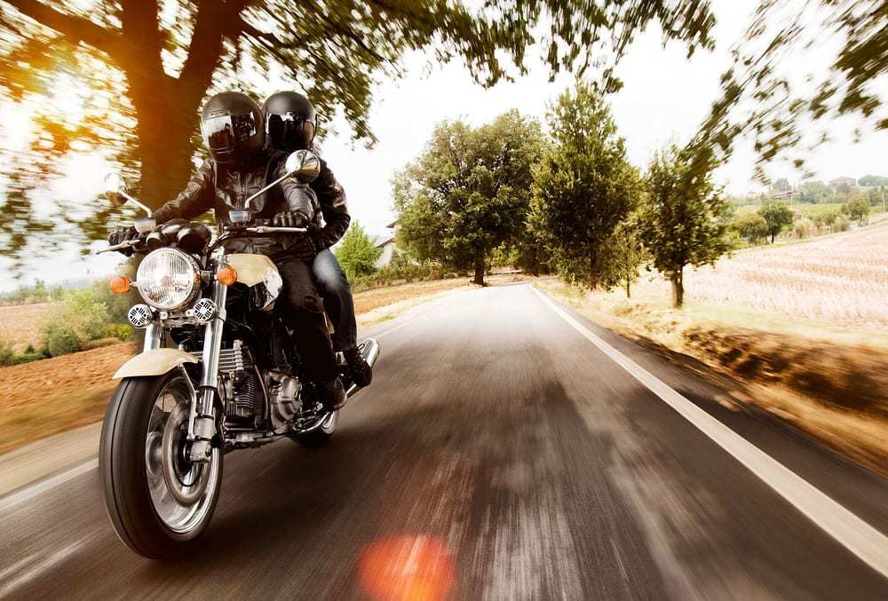 Two people riding on motorcycle