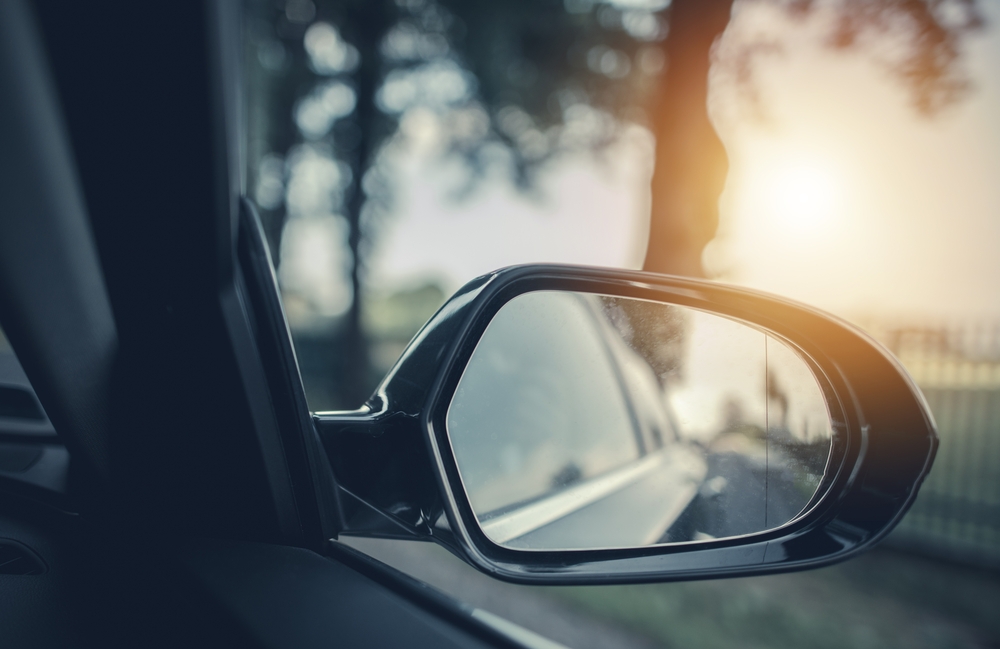 Car rearview mirror while car is on road