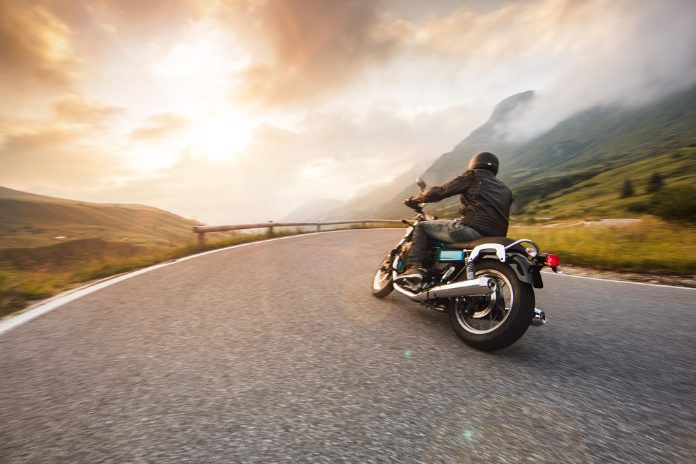 Motorcycle on road at sunset