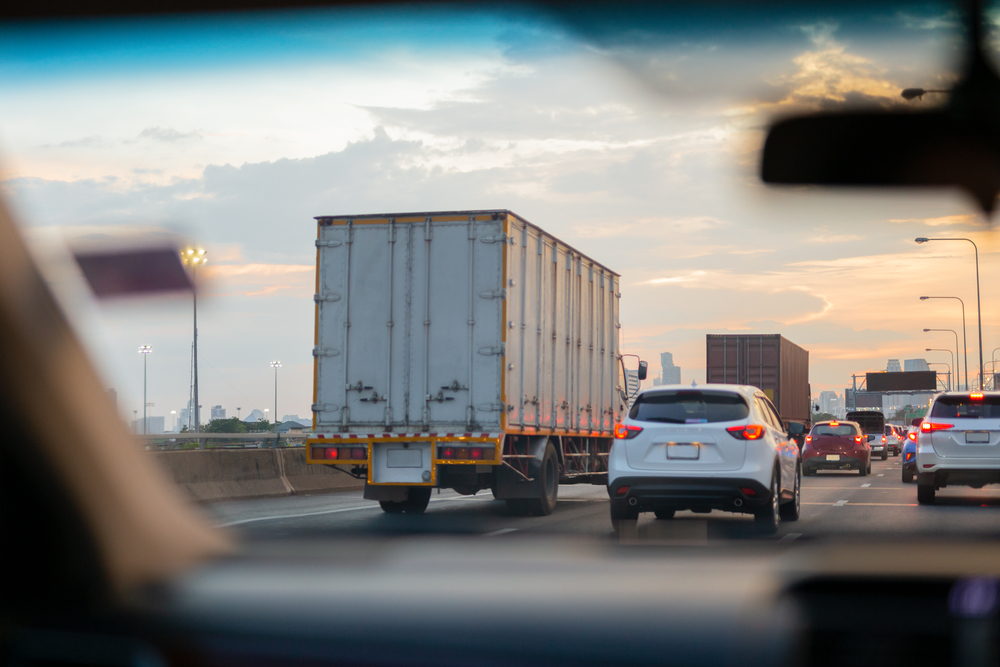 Cars and trucks on a busy highway, view from inside car