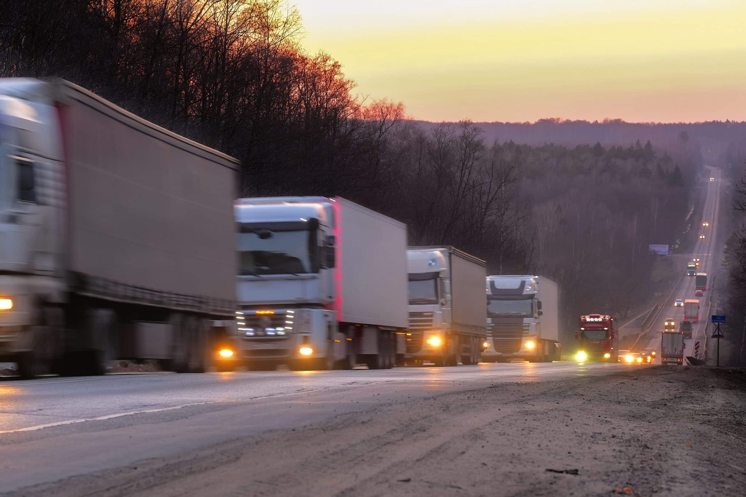 Trucks on a highway in the evening in winter