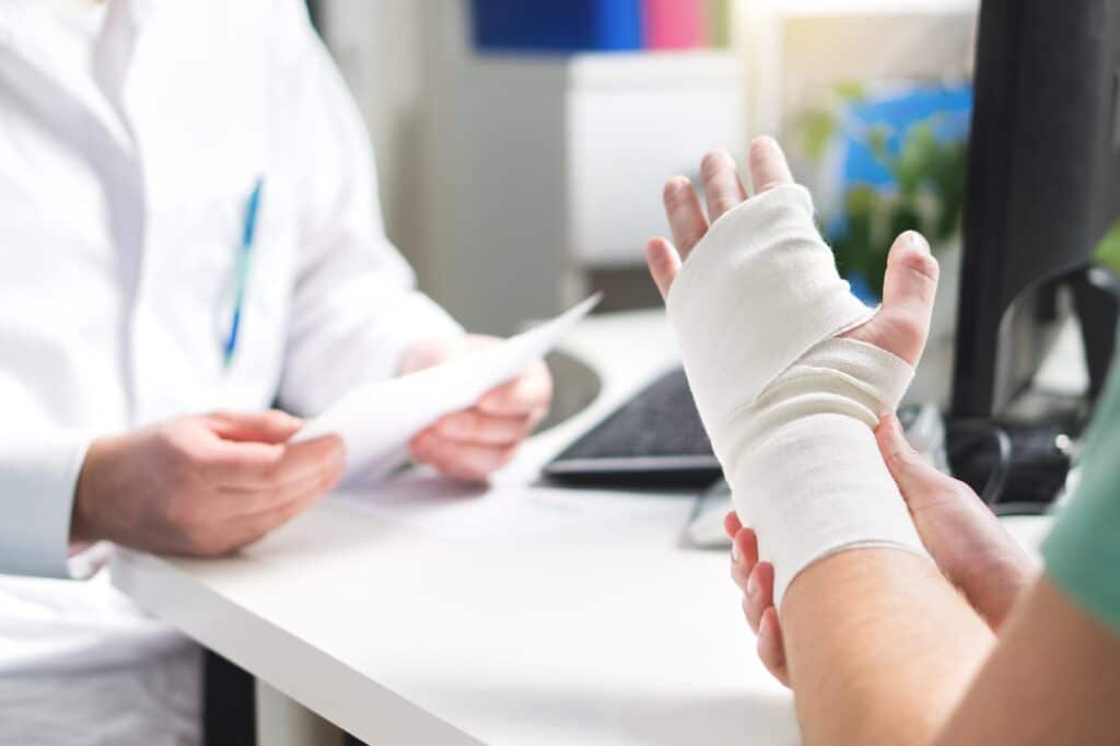 Close-up of person with injured hand or wrist at doctors office