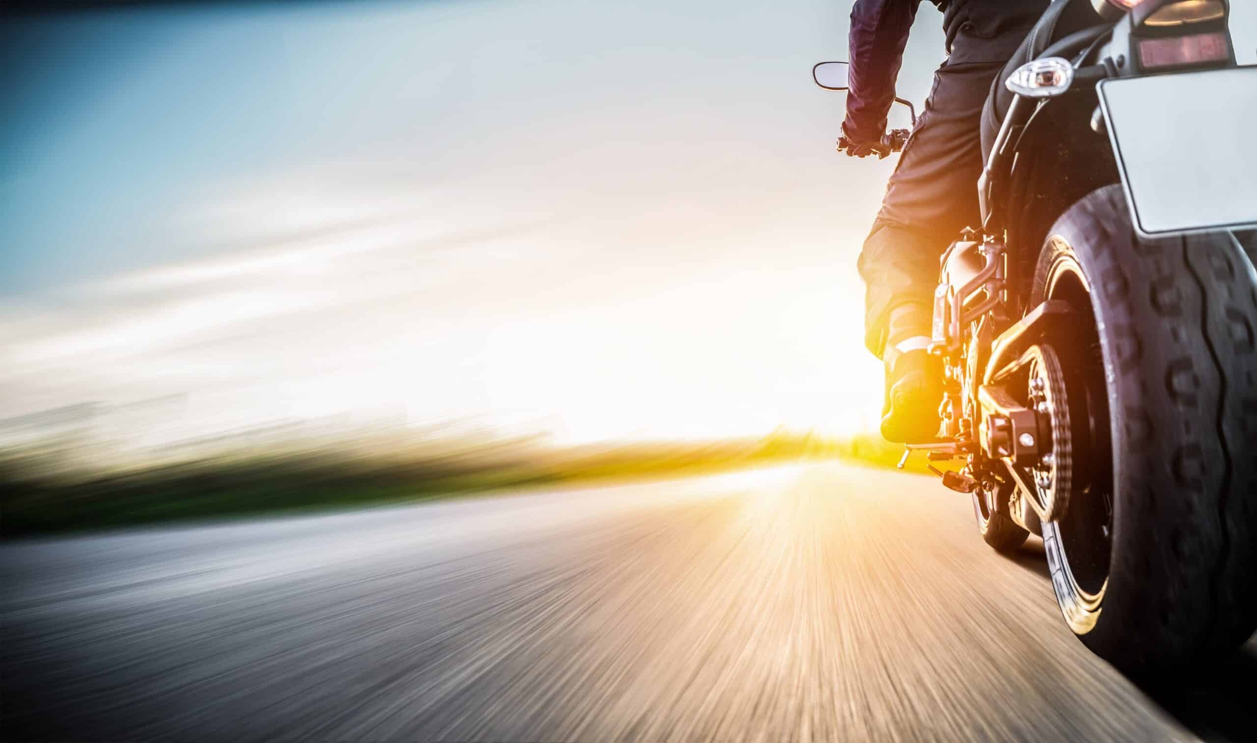 Motorcycle rider an sunset, cropped and blurred