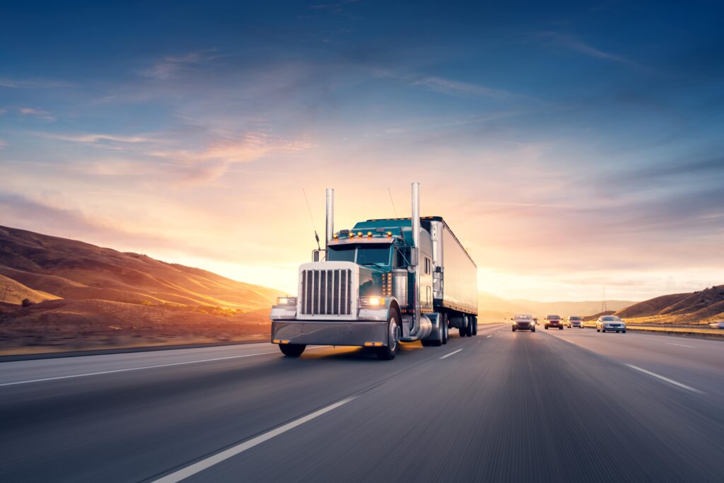 Semi truck on highway at sunrise