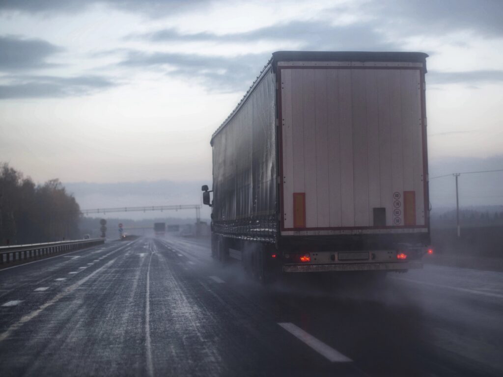 Semi truck on misty wet road