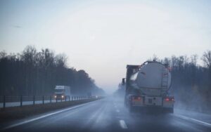 Semi truck on wet road on cloudy day