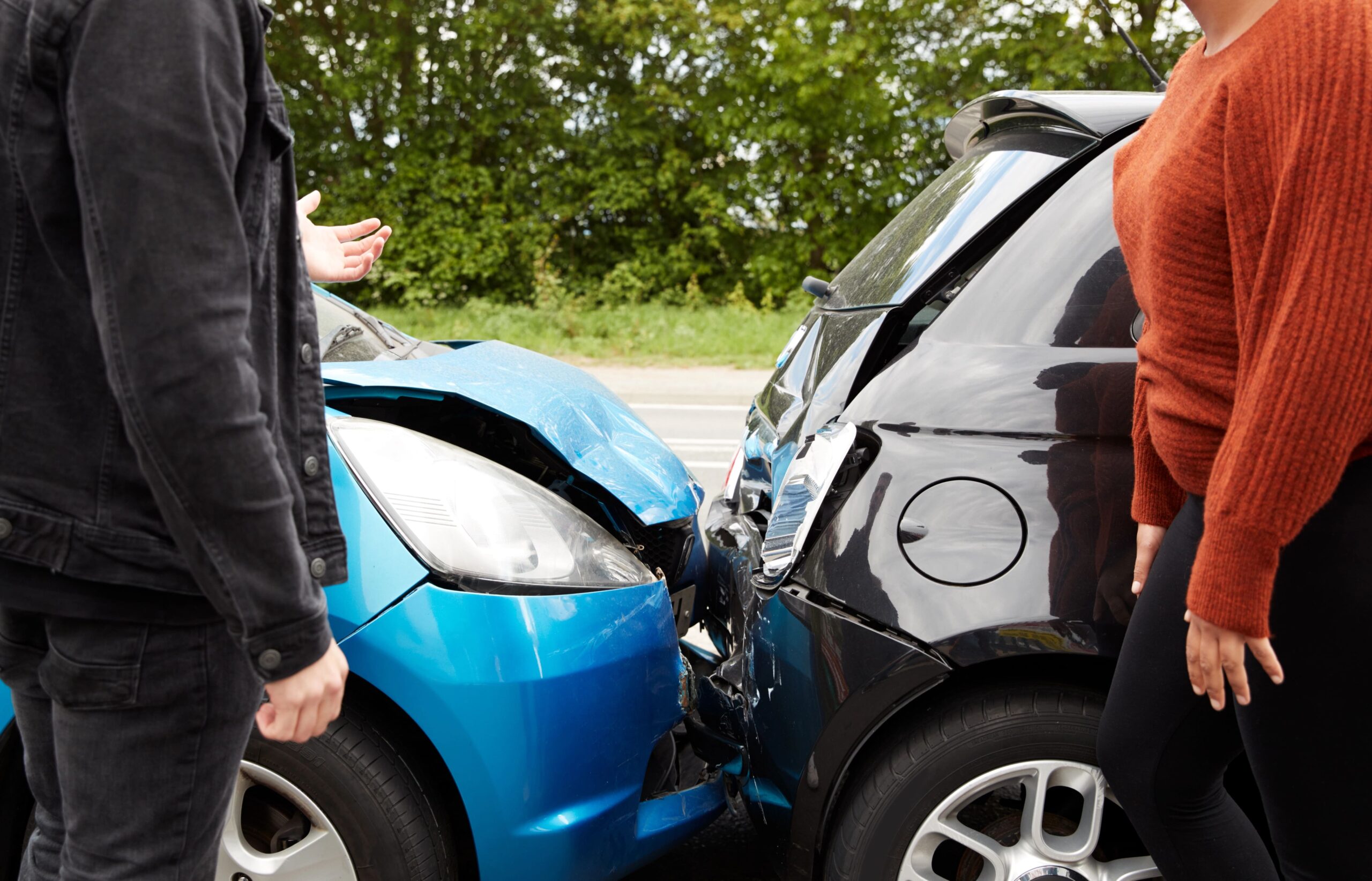 Car crash, close-up of two people talking in front of collision site