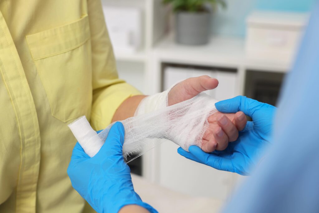 Doctor wrapping arm in gauze