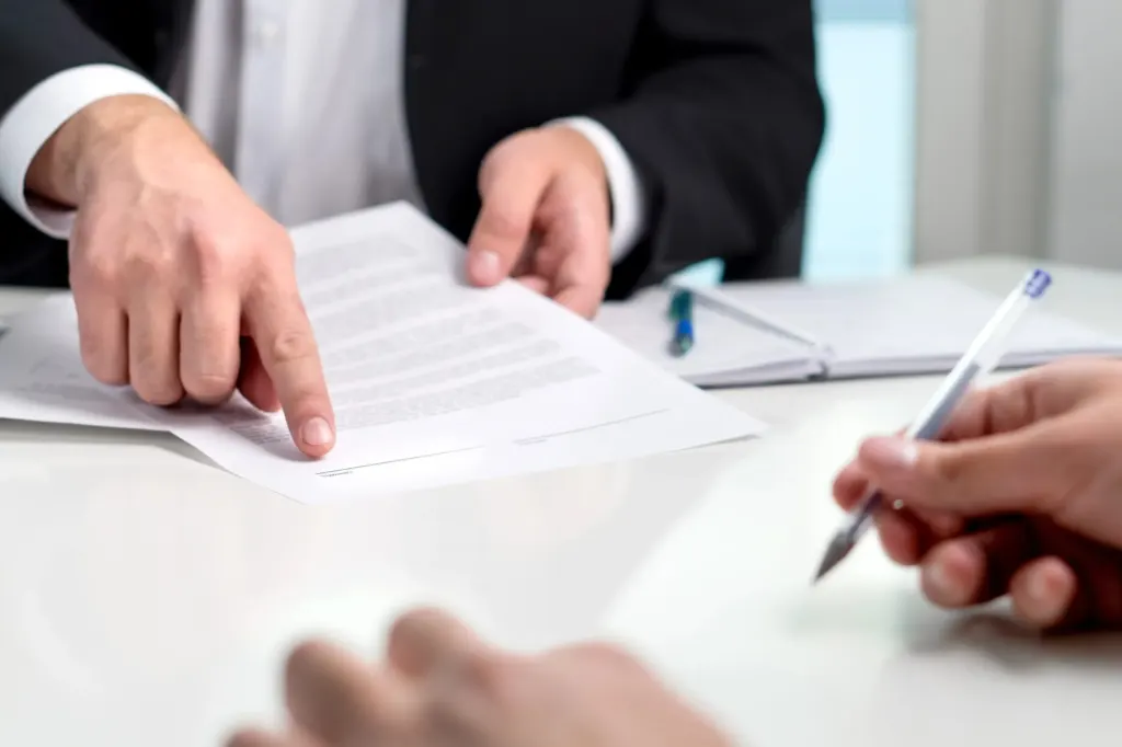 Close-up of man in suit pointing to settlement offer