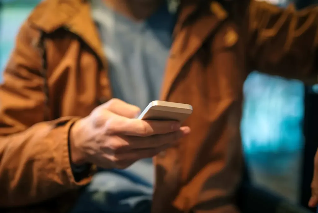 Close-up of man using cell phone