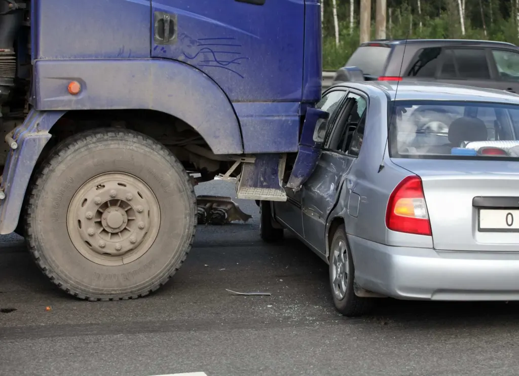 Collision of a truck and car on a busy road