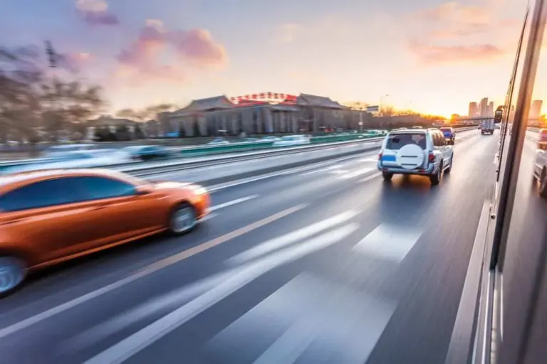 Car driving on freeway at sunset, motion blur