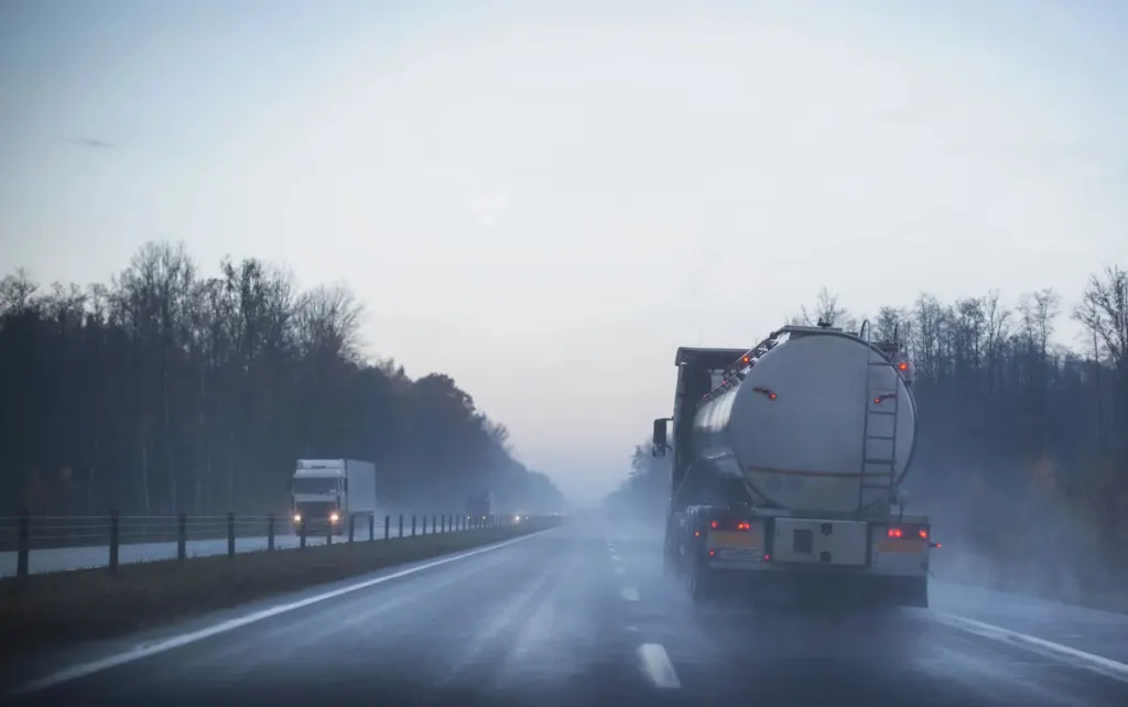 Semi truck on wet road on cloudy day