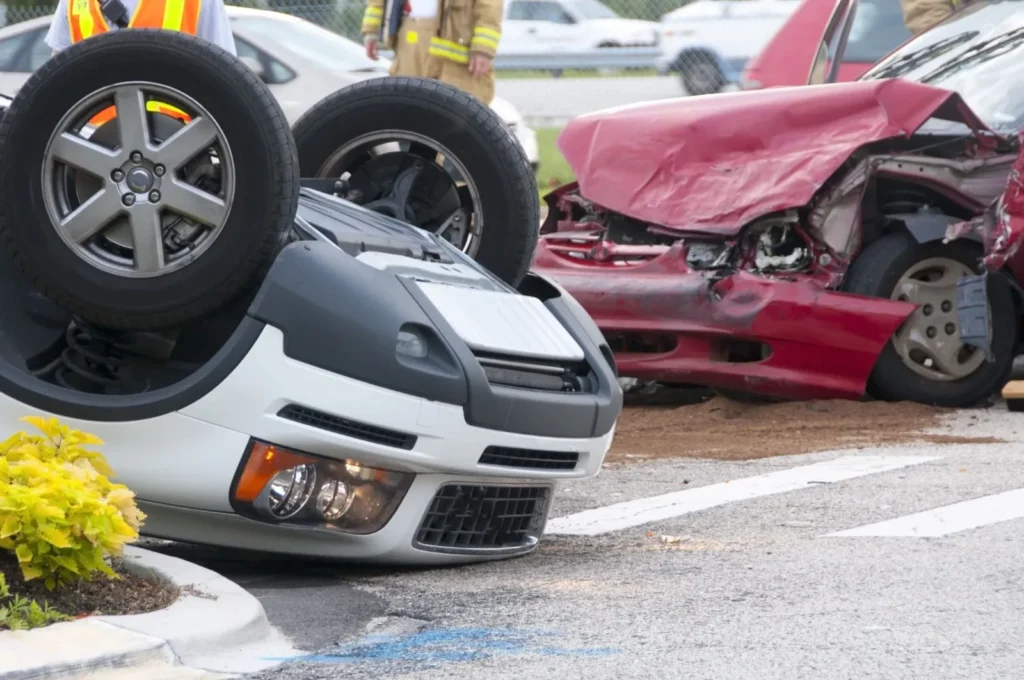 Overturned car and a damaged car after a crash