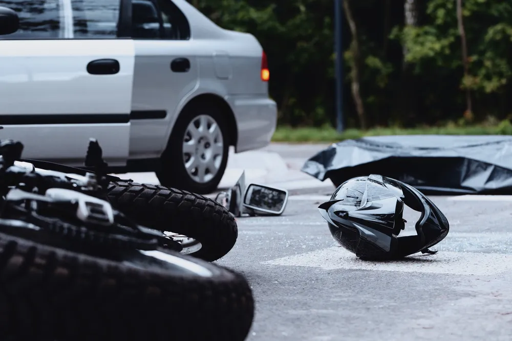 Motorcycle and helmet on the street after a crash