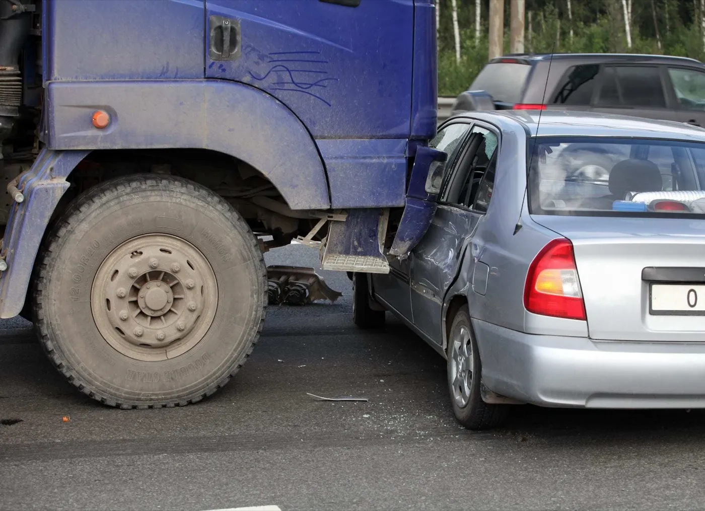 Collision of a truck and car on a busy road